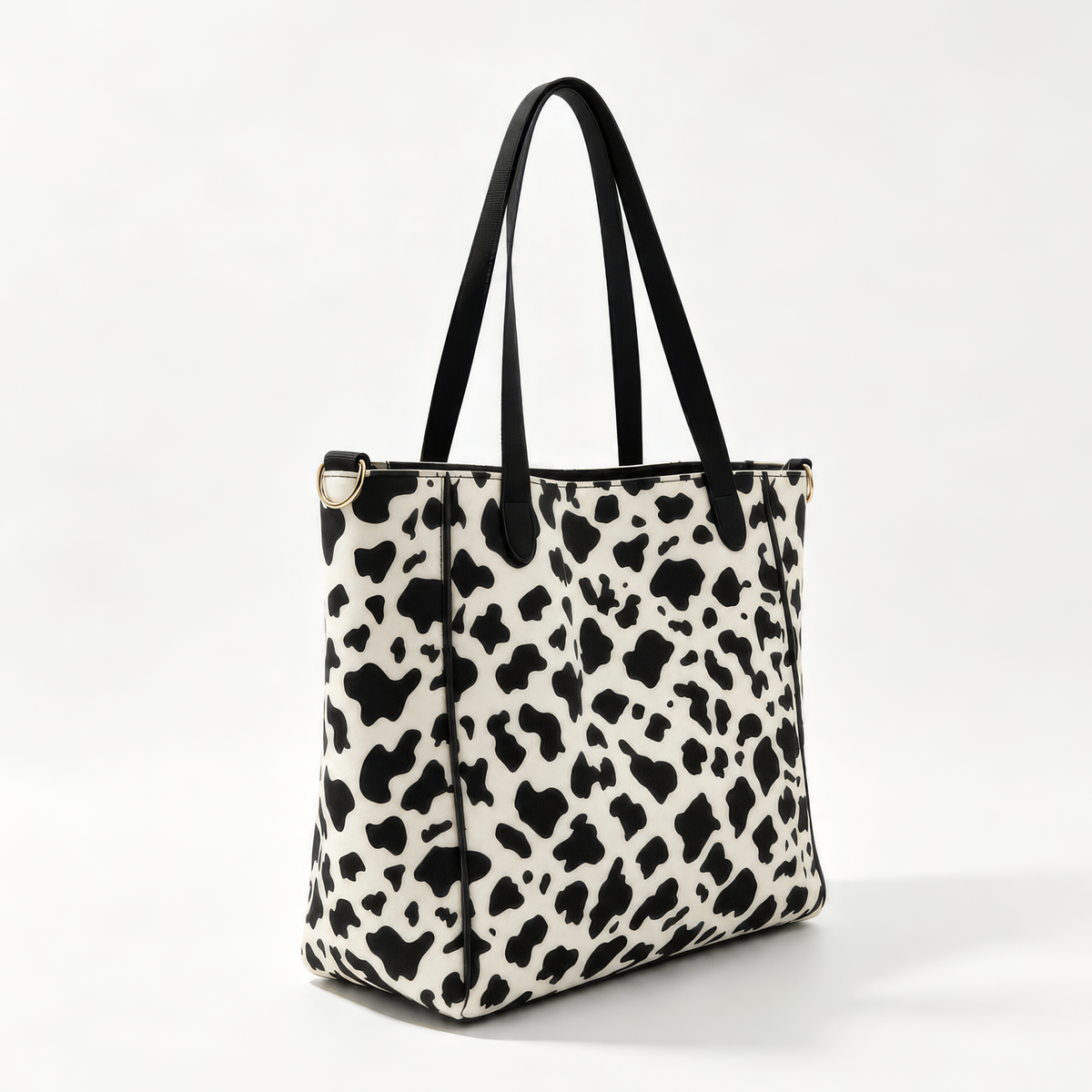 Three-quarter view of the Vitale Dublin cow print neoprene tote with black handles and a green and black striped center