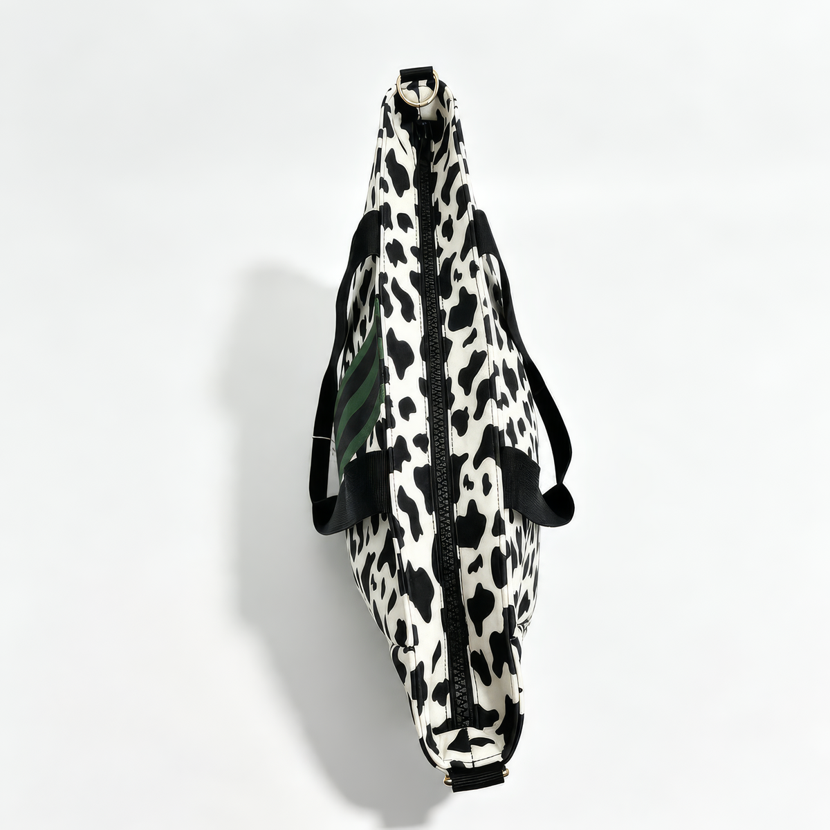 Side view of the Dublin cow print neoprene tote showing its 6 inch depth and gold-tone strap ring