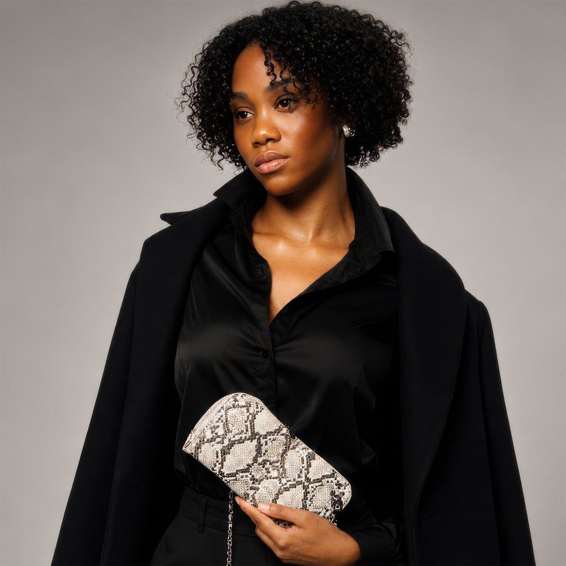 Vitale by Myriad Petrel mini crossbody clutch in natural snake print vegan leather with gunmetal hardware, front view