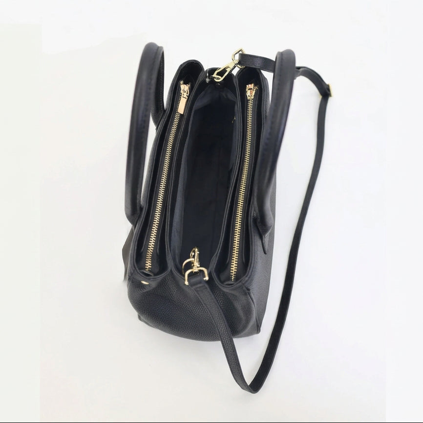 Top-down view of the open Roma black pebbled leather tote showing gold zippers and the lined interior