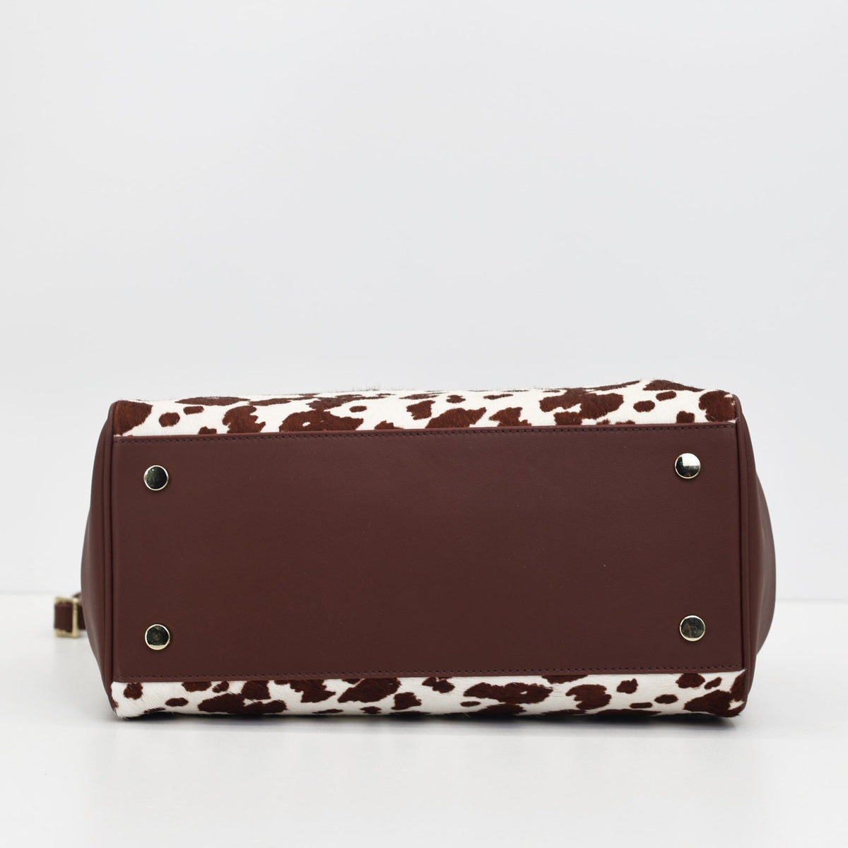 Base of the Roma brown cow hair-on-hide tote with metal studs