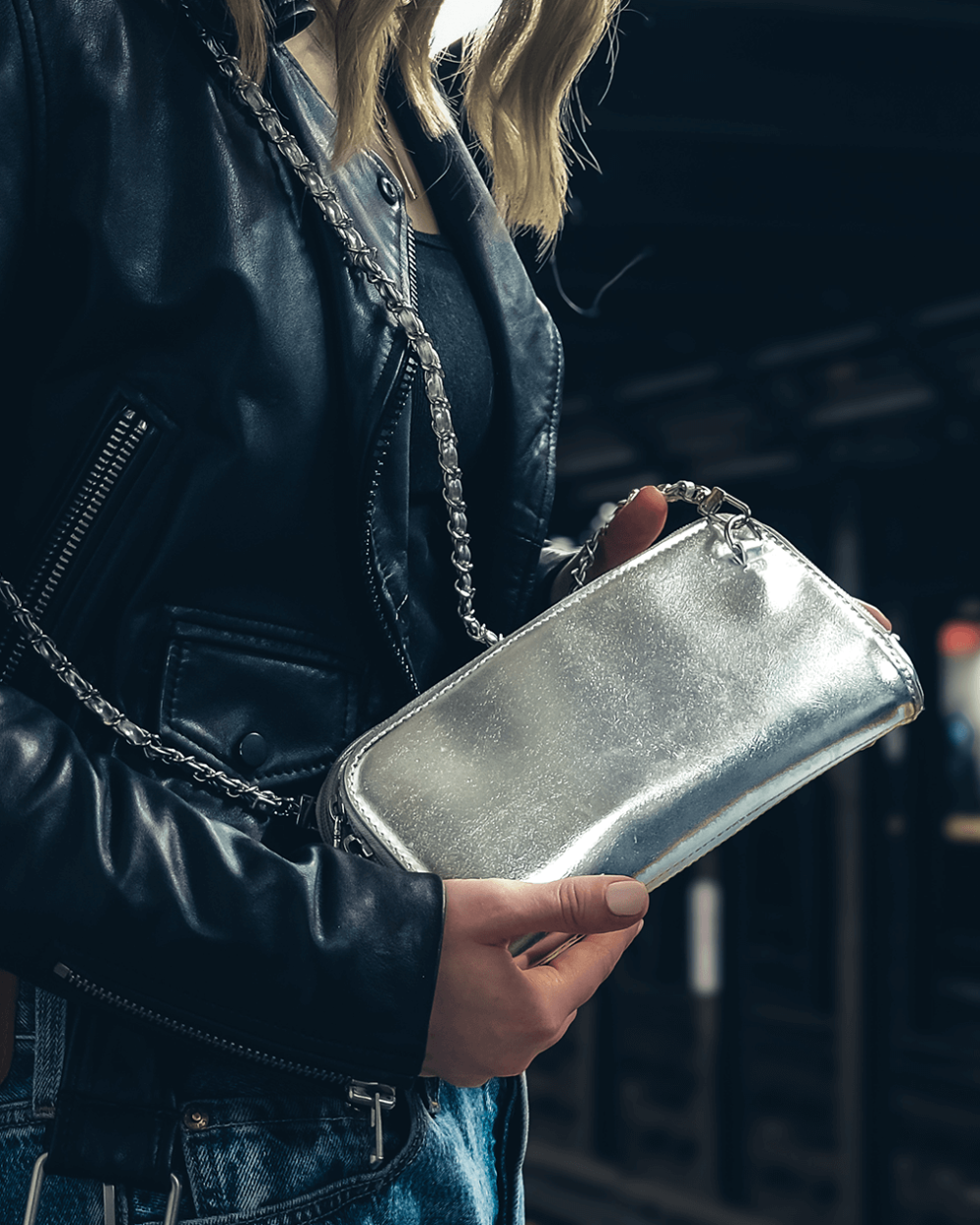 Vitale by Myriad silver clutch lifestyle shot - metallic vegan leather handbag with organized compartments