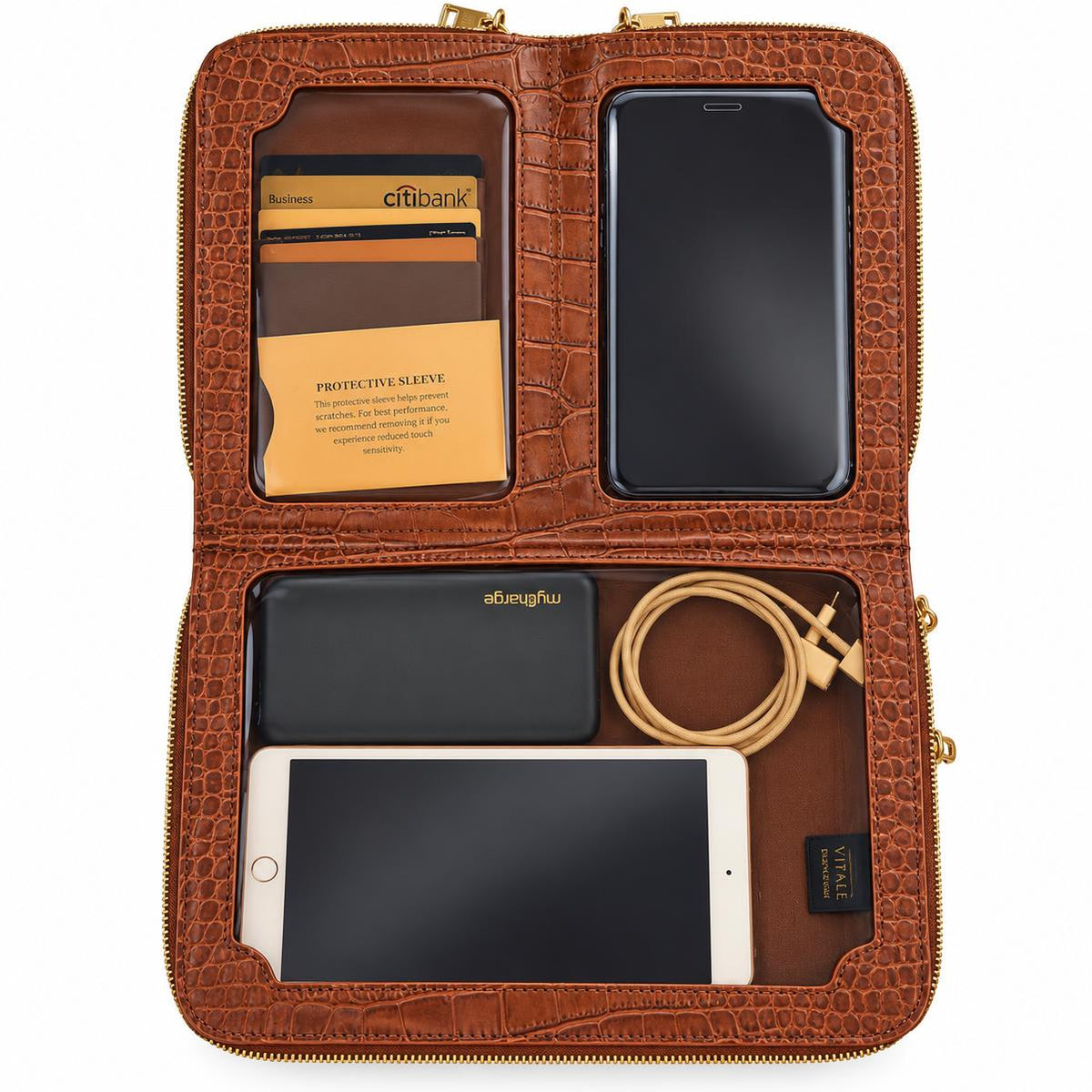 Vallina cognac crossbody open flat showing a card holder, phone, tablet and cable in its compartments