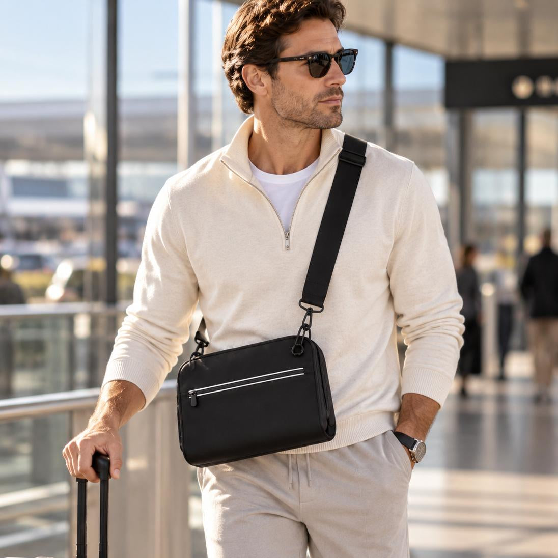 Man in sunglasses wearing the Vallina black neoprene crossbody at an airport