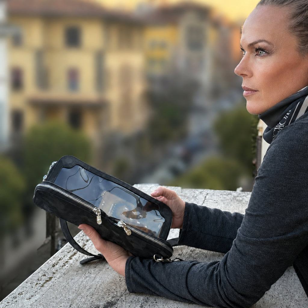 Woman on a balcony in Rome at sunset holding a Zeloso Black Camo leather clutch, Vitale + House of Alimena