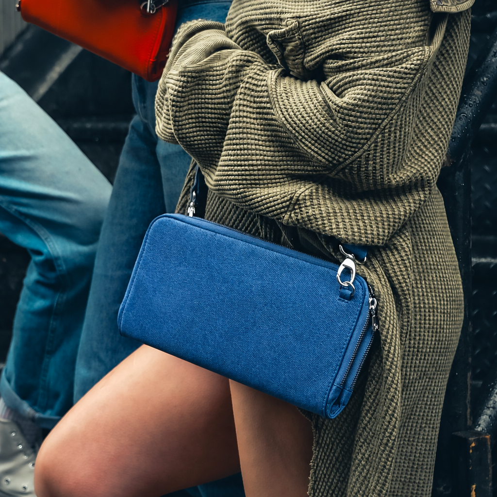 Woman in a green knit cardigan wearing a Zeloso Denim blue leather clutch as a crossbody, Vitale + House of Alimena